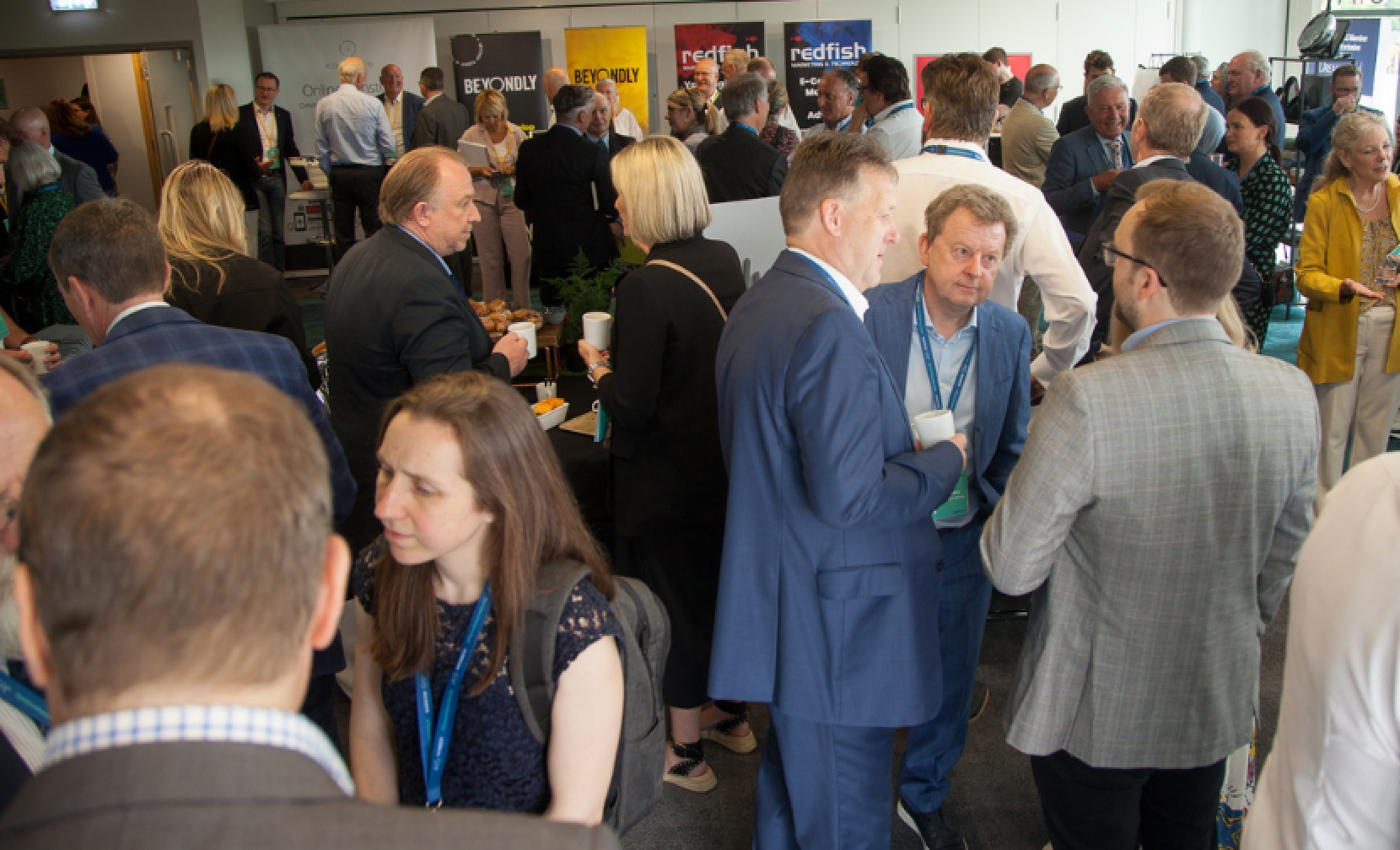 a room of people networking in a large room