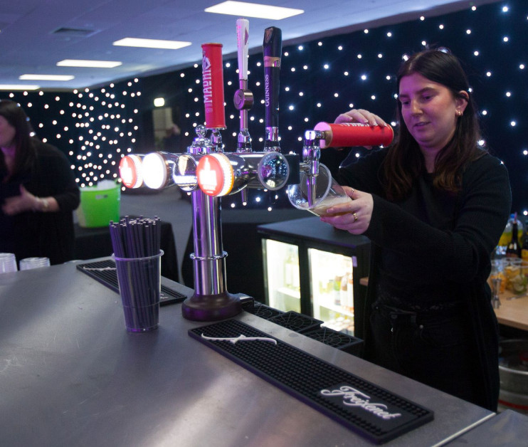 a person pouring a print of beer