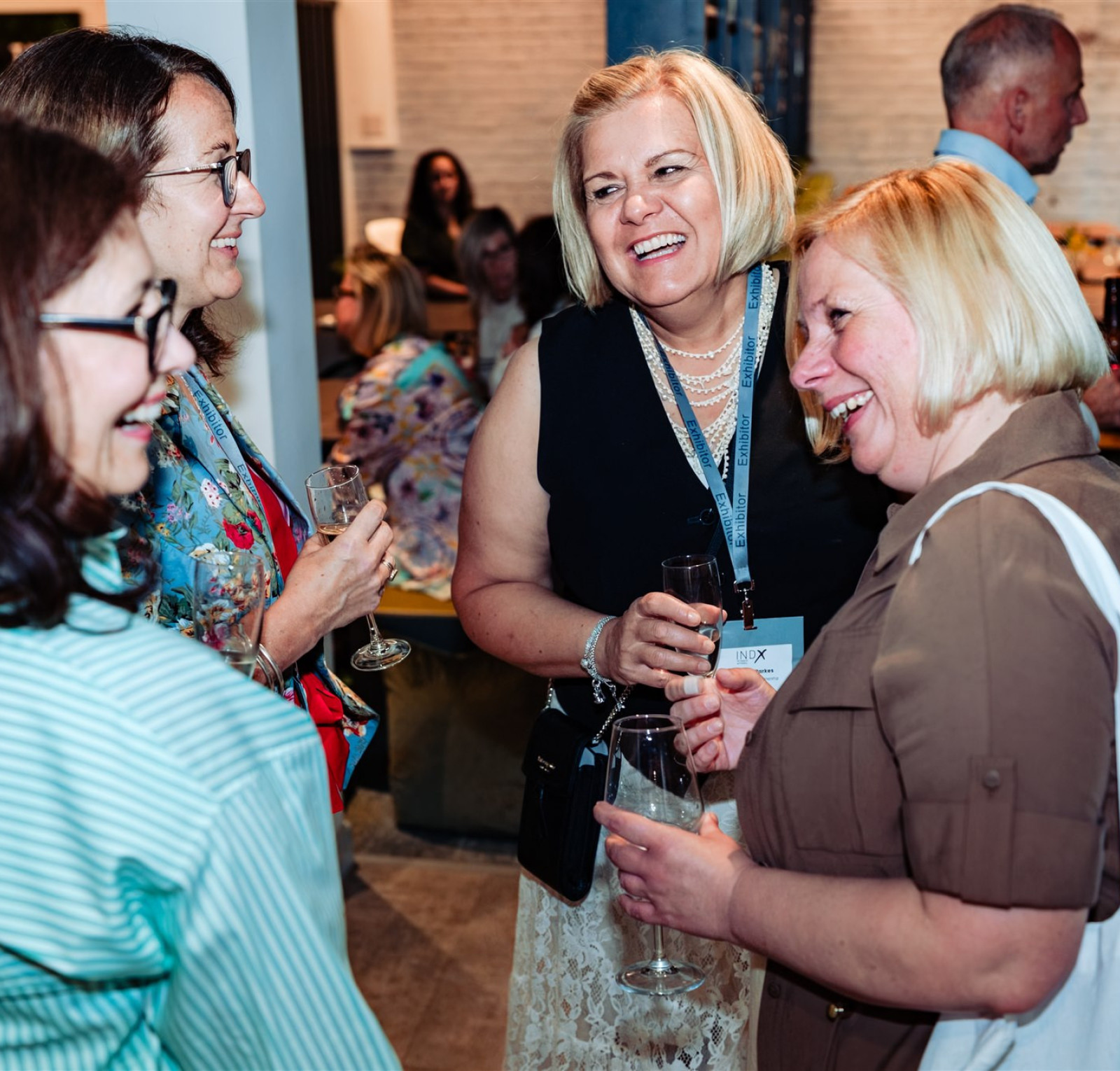 four ladies laughing at a drinks reception