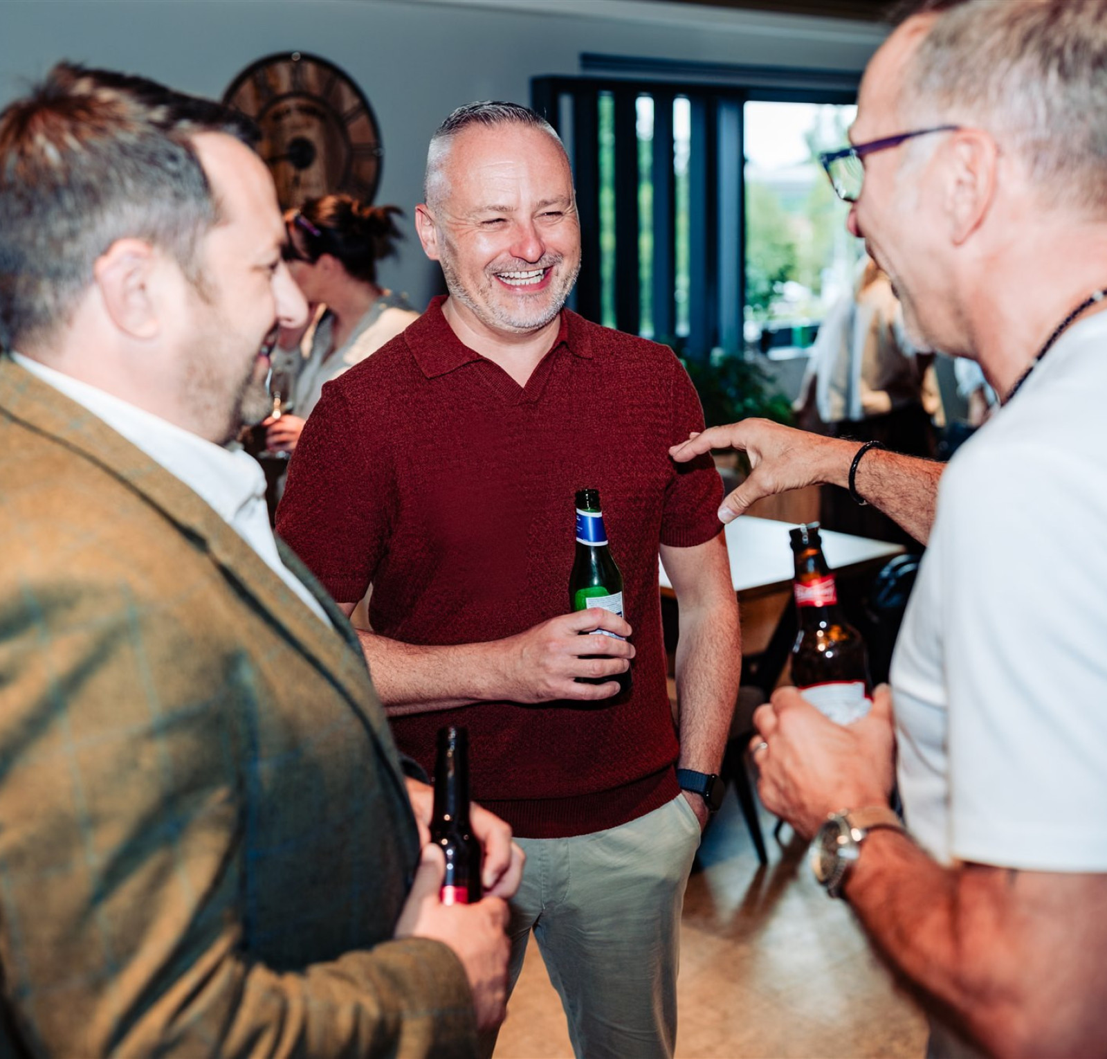 people laughing at a drinks reception