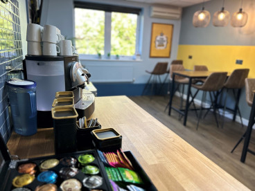 coffee corner with a coffee machine and seats