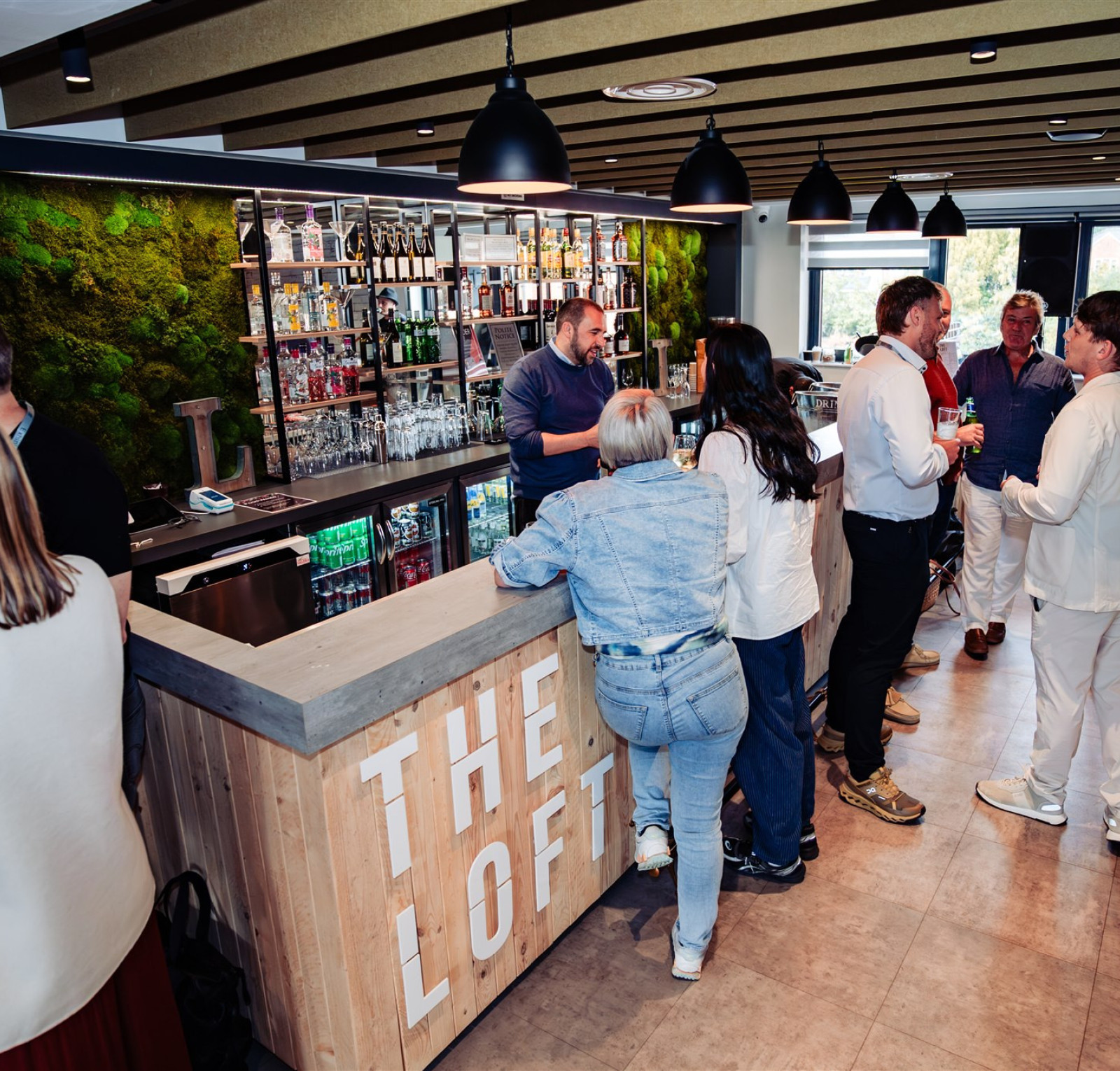 people stood around a modern looking bar