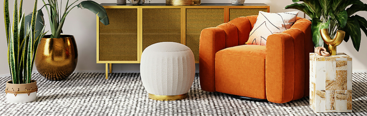 A modern living room featuring an orange armchair, a white textured ottoman, and a decorative side table. There's a gold-accented sideboard in the background, alongside various indoor plants in decorative pots. A patterned rug covers the floor.