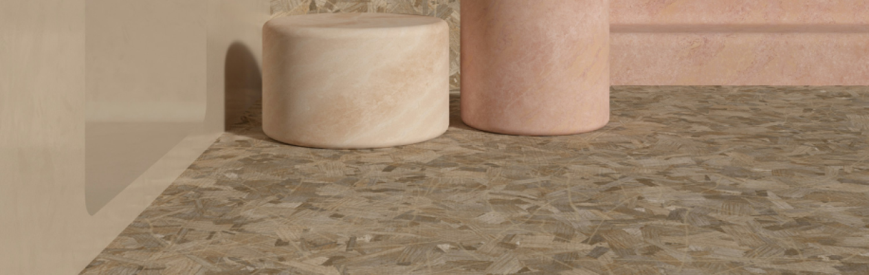 A textured floor featuring abstract patterns in earthy tones, complemented by cylindrical stone-like columns in light peach and beige hues.