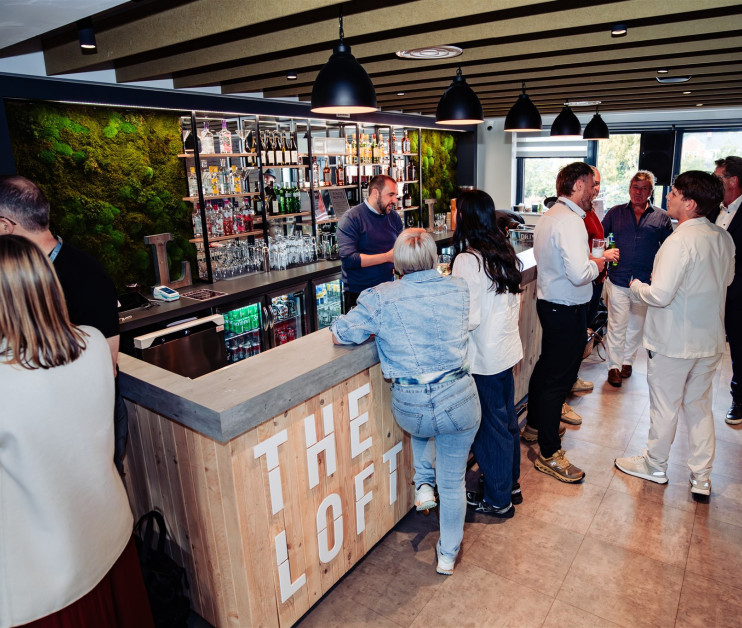 people stood around a modern looking bar