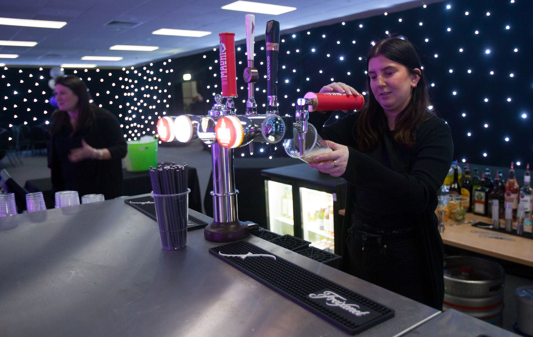 a person pouring a print of beer