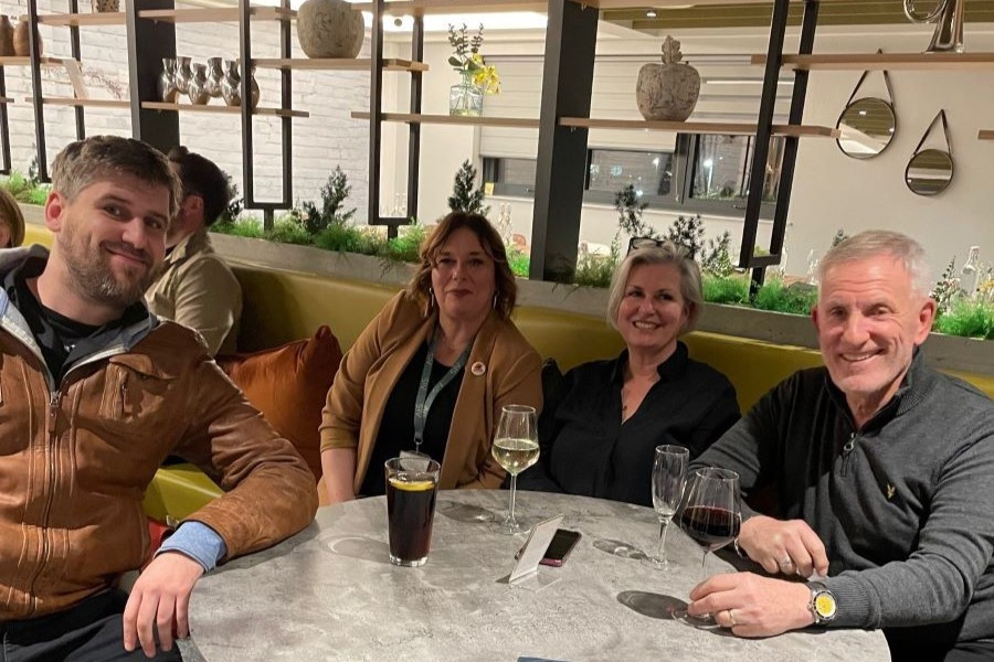 group of people sat around a table drinking