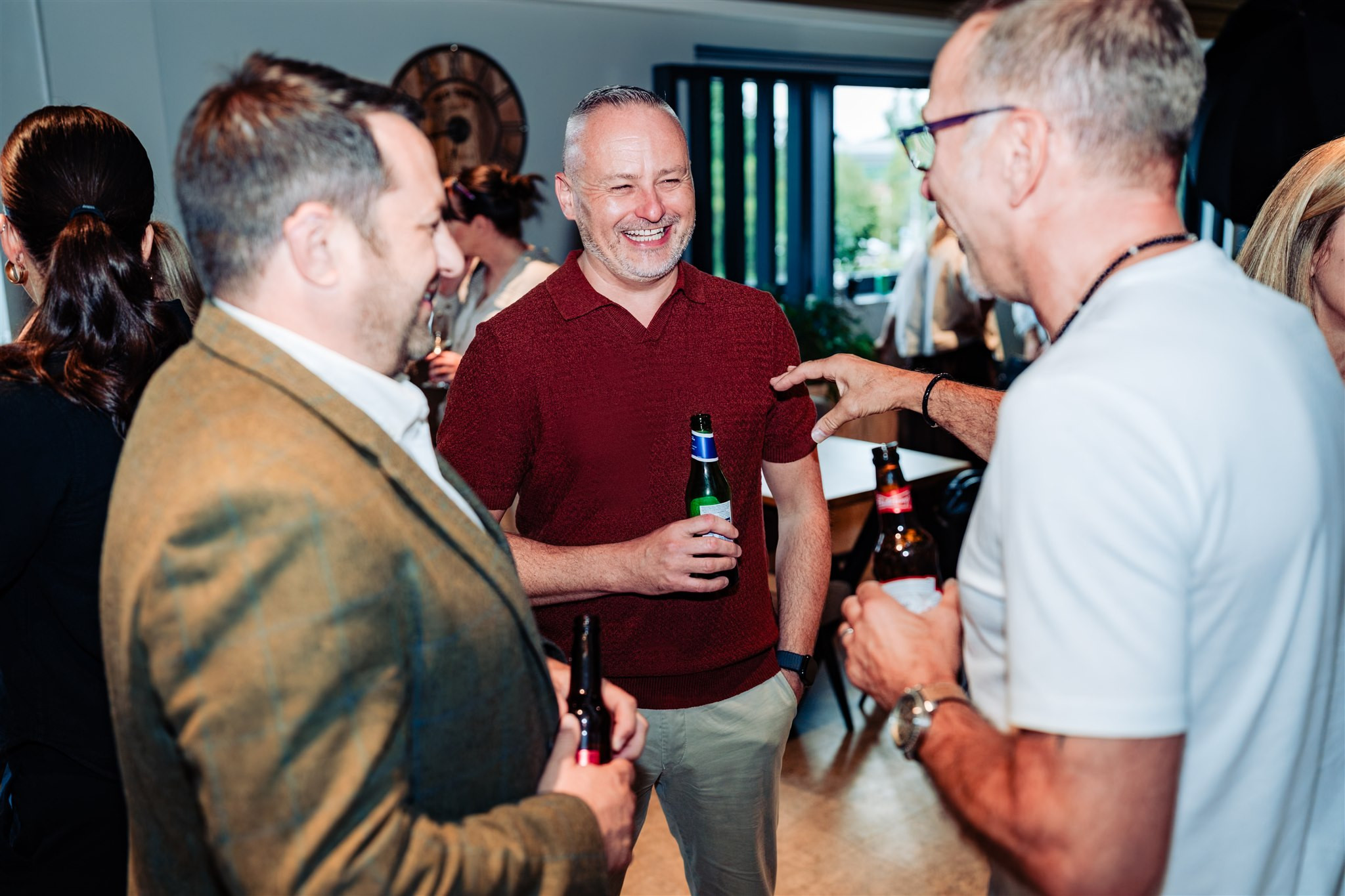 people laughing at a drinks reception