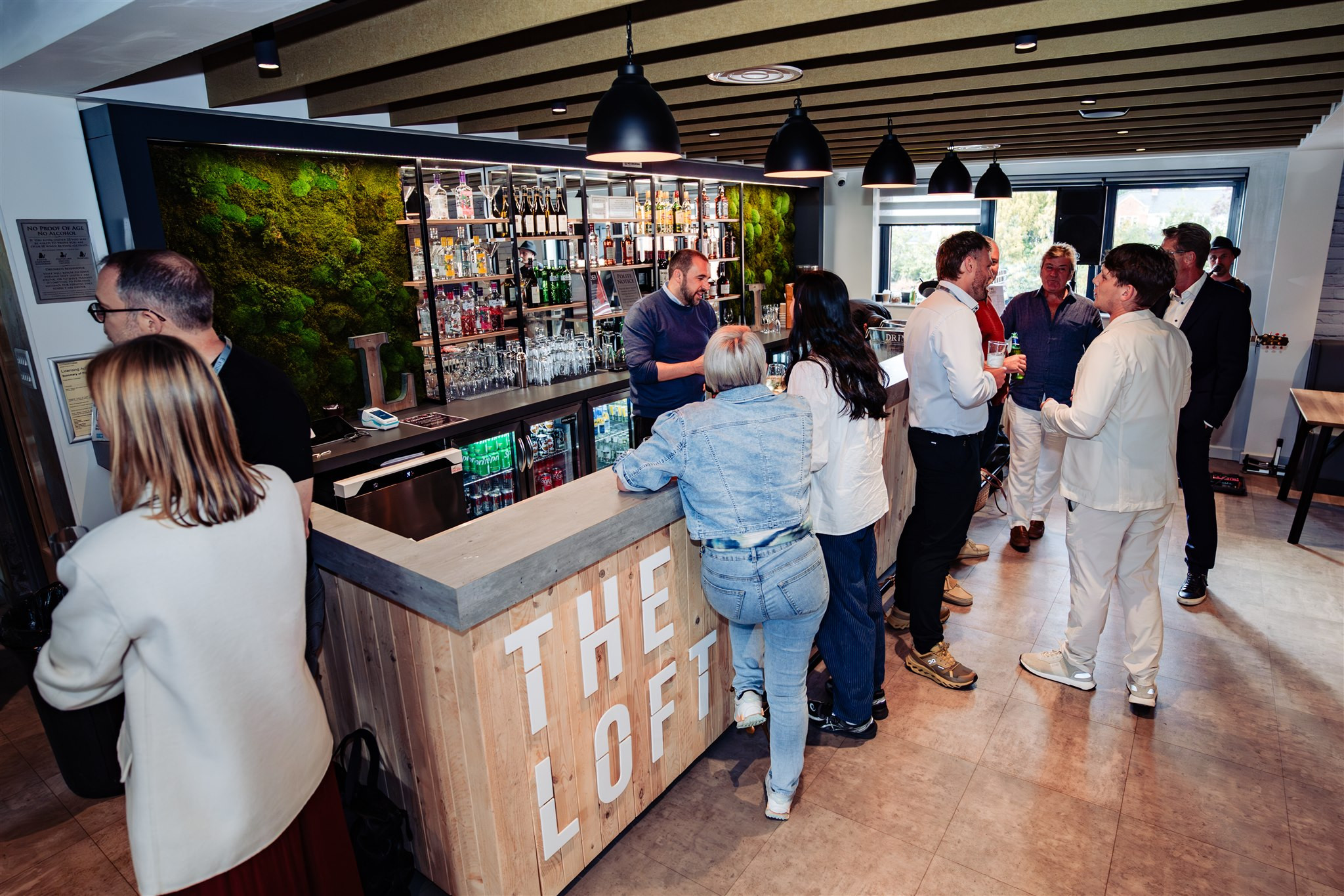 people stood around a modern looking bar